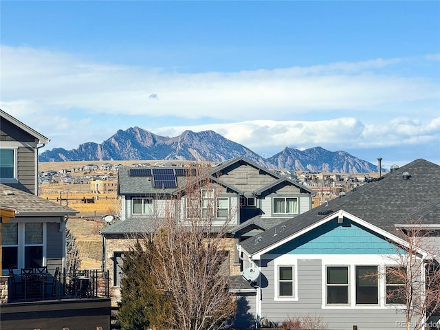 8726 Gardenia Cir, Arvada, CO 80005 - view of front facade featuring a mountain view, solar panels, and a shingled roof