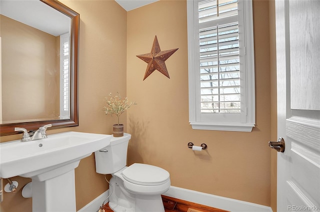 8726 Gardenia Cir, Arvada, CO 80005 - bathroom with baseboards, toilet, a sink, and wood finished floors