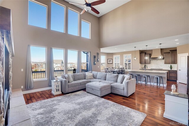 8726 Gardenia Cir, Arvada, CO 80005 - living area featuring a ceiling fan, dark wood-type flooring, a towering ceiling, and recessed lighting