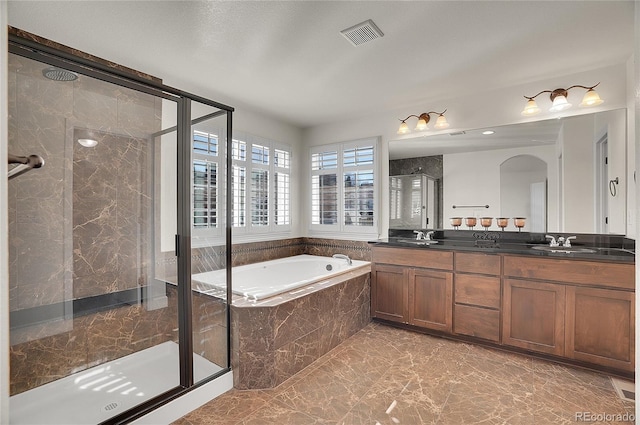 8726 Gardenia Cir, Arvada, CO 80005 - full bath featuring marble look tile flooring, a stall shower, a bath, and double vanity
