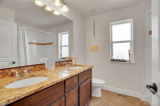 8726 Gardenia Cir, Arvada, CO 80005 - full bathroom with double vanity, baseboards, toilet, and a shower with curtain
