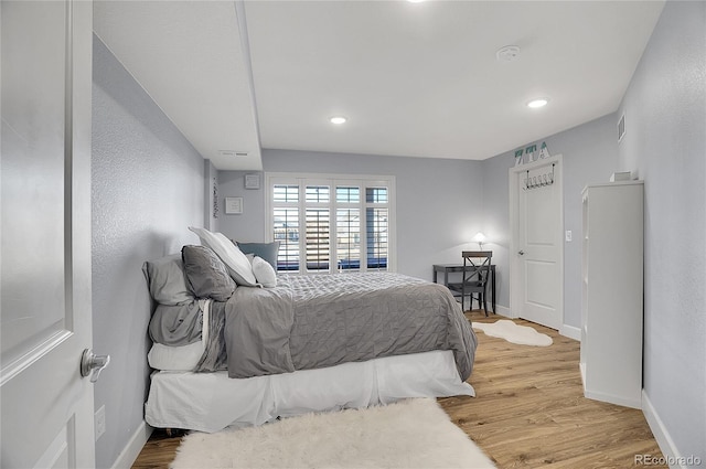 8726 Gardenia Cir, Arvada, CO 80005 - bedroom with light wood-style floors, baseboards, and recessed lighting