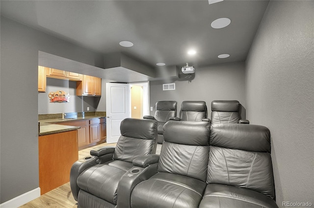 8726 Gardenia Cir, Arvada, CO 80005 - cinema with light wood-style flooring, baseboards, recessed lighting, and a textured wall