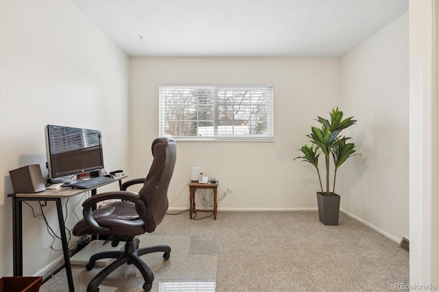 carpeted home office with baseboards