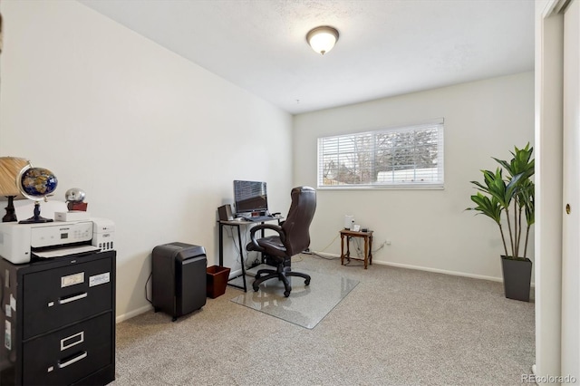 carpeted home office with baseboards