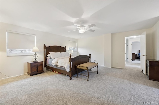 bedroom with a ceiling fan, baseboards, and carpet floors