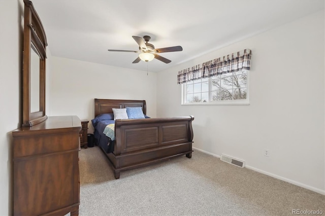 bedroom with visible vents, baseboards, light colored carpet, and ceiling fan