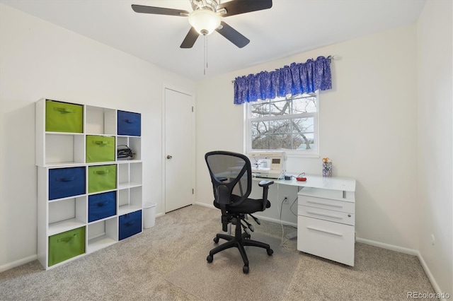 home office featuring carpet flooring, ceiling fan, and baseboards