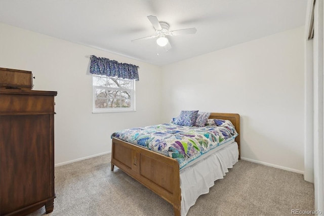 carpeted bedroom with ceiling fan and baseboards