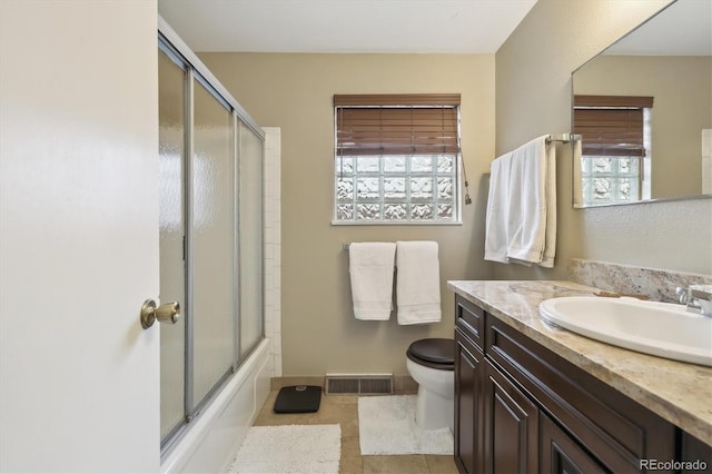 bathroom with visible vents, plenty of natural light, toilet, and vanity