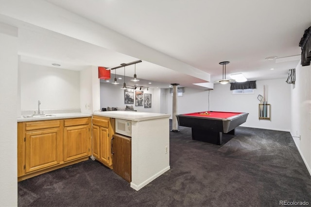 interior space with billiards, baseboards, wet bar, a sink, and dark carpet