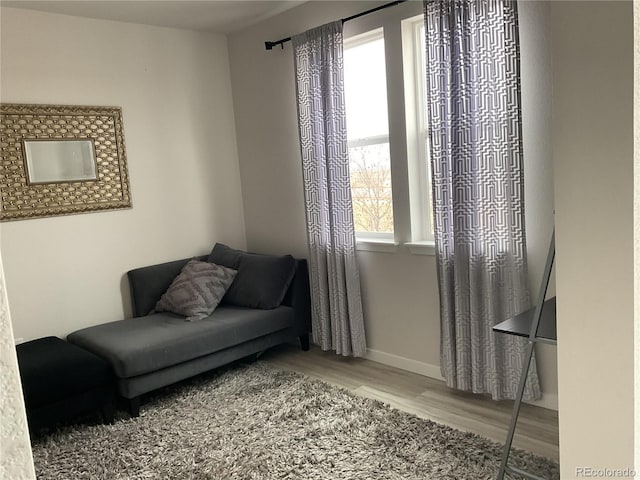 sitting room with wood finished floors and baseboards