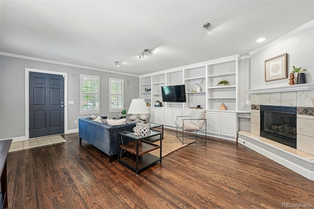 living room with crown molding, a fireplace, dark wood-style floors, and baseboards