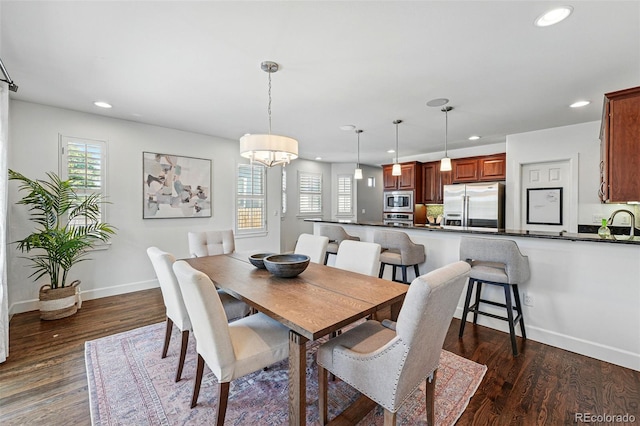dining room with recessed lighting, healthy amount of natural light, dark wood-style floors, and baseboards