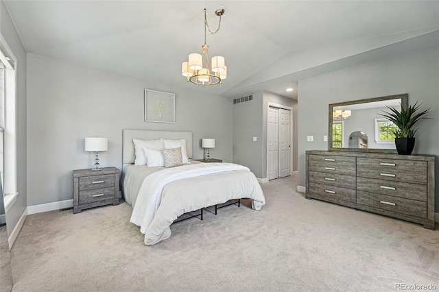 bedroom featuring a chandelier, vaulted ceiling, baseboards, carpet flooring, and a closet