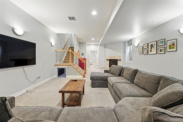 carpeted living room featuring stairs, baseboards, a fireplace, and recessed lighting