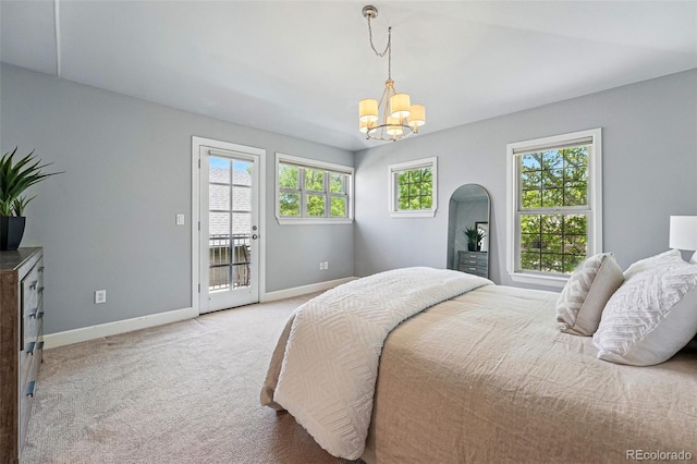 bedroom featuring a chandelier, baseboards, access to exterior, carpet, and arched walkways