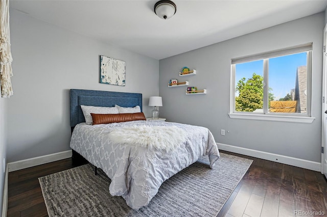 bedroom featuring baseboards and wood finished floors