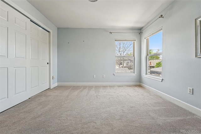 unfurnished bedroom featuring carpet flooring and baseboards