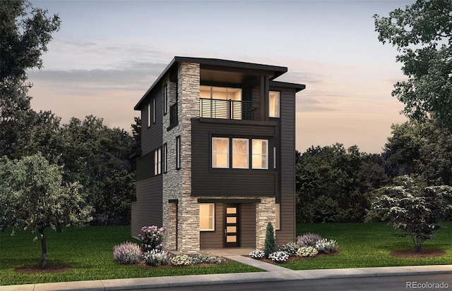 8628 Hotchkiss St, Littleton, CO 80125 - modern home featuring a balcony, stone siding, and a lawn