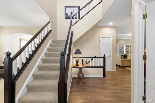 6772 Tiger Tooth, Littleton, CO 80124 - staircase with hardwood / wood-style flooring, arched walkways, and recessed lighting