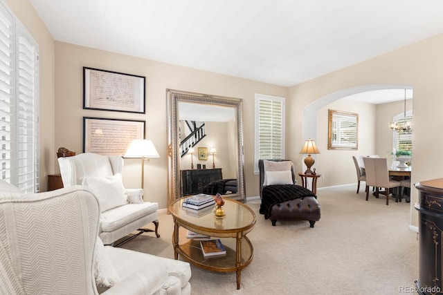 6772 Tiger Tooth, Littleton, CO 80124 - living area with a chandelier, carpet flooring, and arched walkways