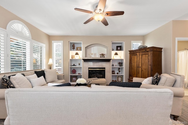 6772 Tiger Tooth, Littleton, CO 80124 - living room with ceiling fan, healthy amount of natural light, a tile fireplace, and wood finished floors