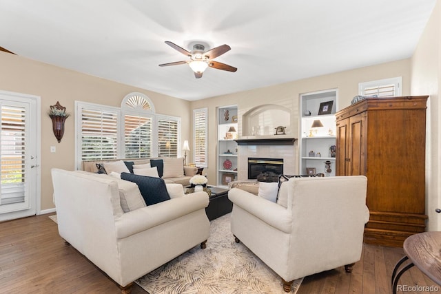 6772 Tiger Tooth, Littleton, CO 80124 - living area featuring ceiling fan, a glass covered fireplace, and light wood-style floors