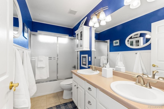 6772 Tiger Tooth, Littleton, CO 80124 - full bathroom with wainscoting, enclosed tub / shower combo, double vanity, tile patterned flooring, and ornamental molding