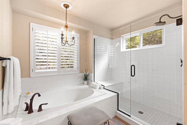 6772 Tiger Tooth, Littleton, CO 80124 - full bath with a stall shower, a garden tub, and a chandelier