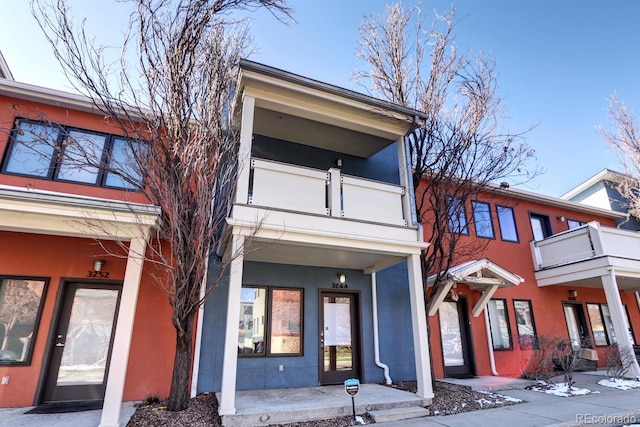 view of front of property featuring a balcony and stucco siding