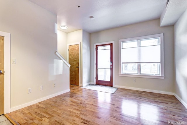 entryway featuring light wood-type flooring and baseboards