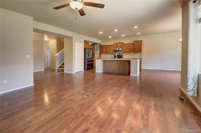 5947 Cumbre Vista Way, Colorado Springs, CO 80924 - unfurnished living room with dark wood finished floors, a ceiling fan, stairway, and recessed lighting