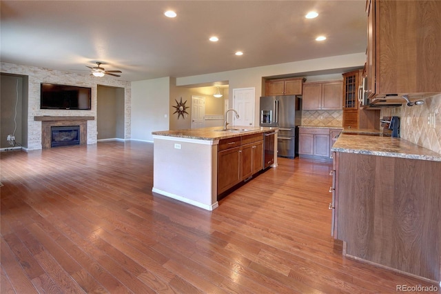 5947 Cumbre Vista Way, Colorado Springs, CO 80924 - kitchen with appliances with stainless steel finishes, a ceiling fan, backsplash, brown cabinets, and recessed lighting