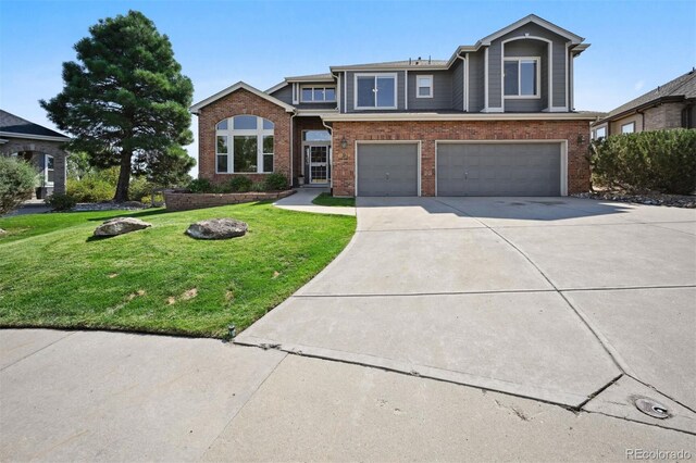 view of front facade featuring driveway, an attached garage, a front lawn, and brick siding