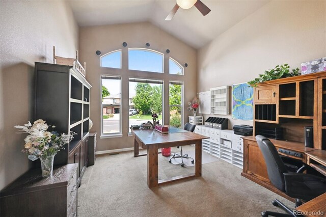 office space featuring baseboards, carpet, high vaulted ceiling, and a ceiling fan