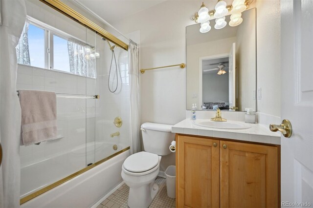 ensuite bathroom featuring connected bathroom, toilet, shower / bath combination with glass door, tile patterned flooring, and vanity