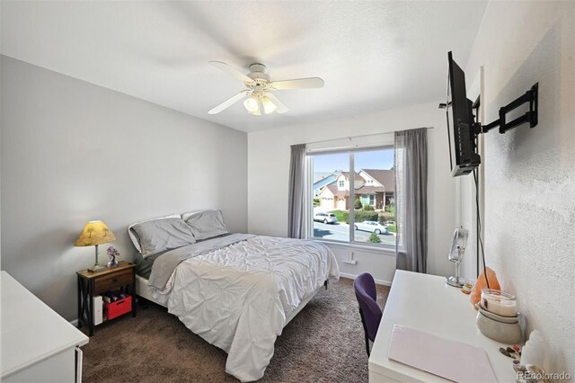 carpeted bedroom with a ceiling fan and baseboards