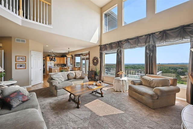 living area with visible vents, baseboards, and wood finished floors