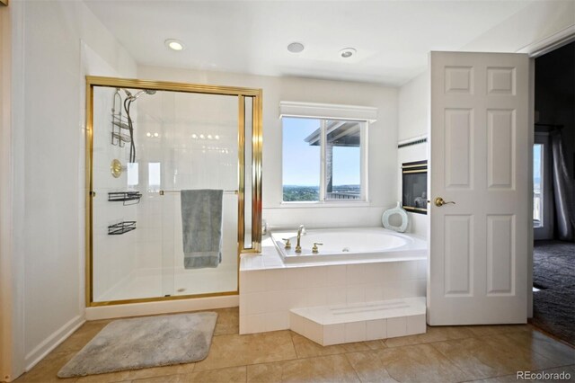 full bath with a shower stall, a bath, and tile patterned floors