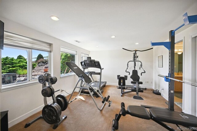 exercise area featuring recessed lighting, carpet flooring, and baseboards