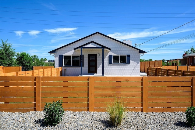 4901 W 11th Ave, Denver, CO 80204 - bungalow-style house featuring brick siding and a fenced front yard