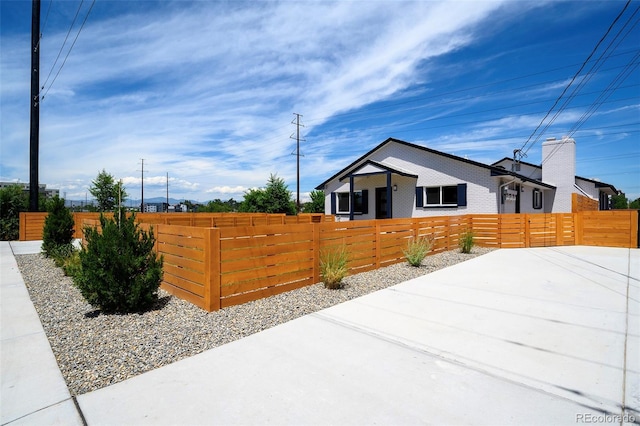 4901 W 11th Ave, Denver, CO 80204 - view of side of home with a fenced front yard and brick siding