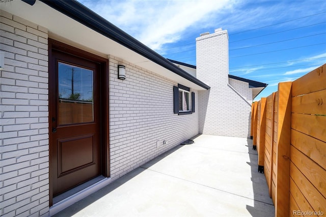 4901 W 11th Ave, Denver, CO 80204 - entrance to property featuring brick siding, a patio, and a chimney