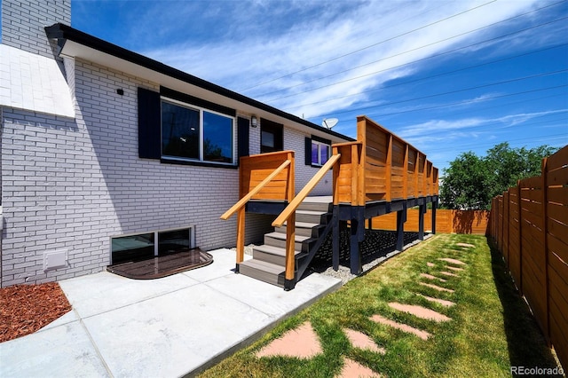 4901 W 11th Ave, Denver, CO 80204 - back of property with brick siding, a fenced backyard, a patio area, and a deck