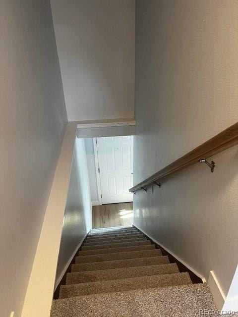 staircase with wood finished floors