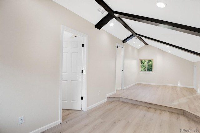 bonus room featuring lofted ceiling with beams and light hardwood / wood-style flooring