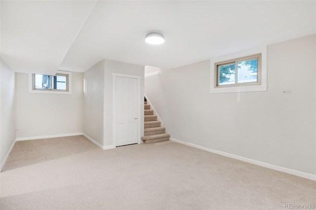 basement featuring light carpet