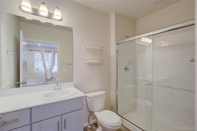 12225 W 57th Pl, Arvada, CO 80002 - bathroom featuring vanity, a shower stall, and toilet