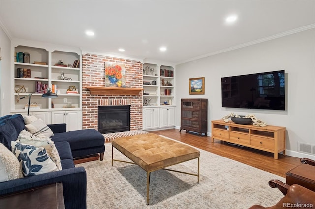 3566 E Meadow Creek Pl, Highlands Ranch, CO 80126 - living room featuring crown molding, a brick fireplace, wood finished floors, baseboards, and built in shelves